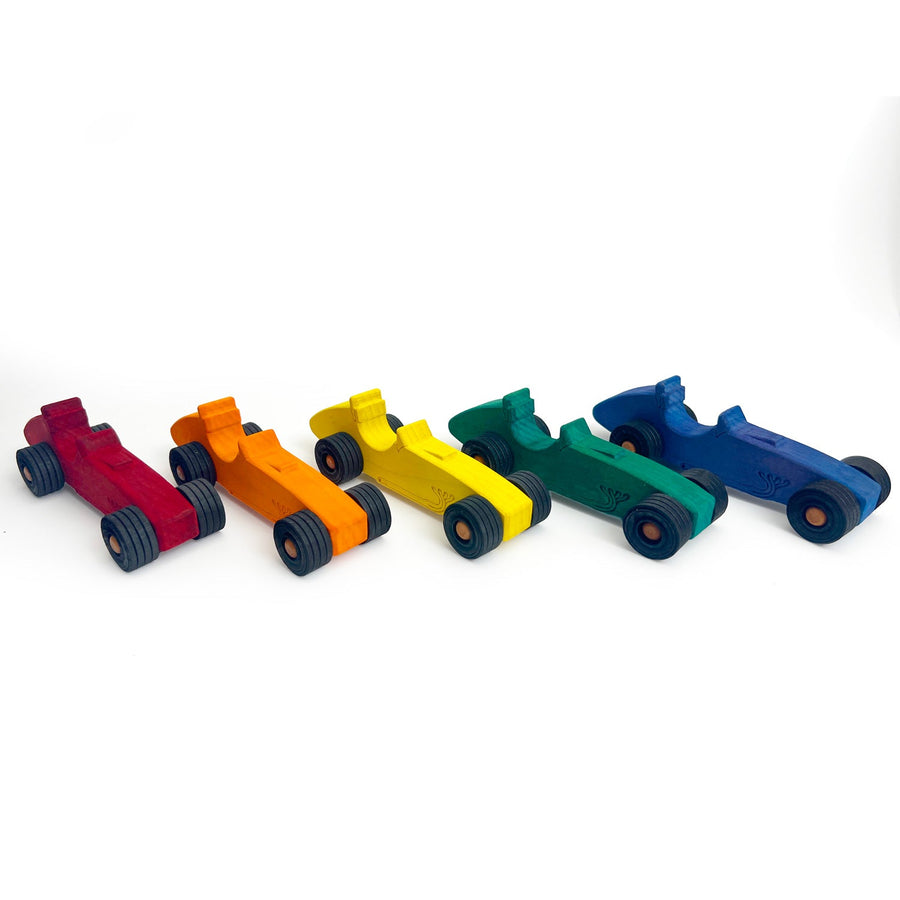 Colorful wooden Indy-style toy cars arranged for racing play