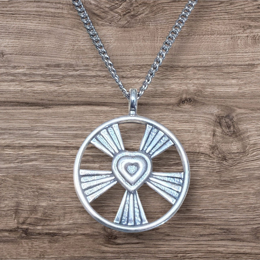 Shining Heart pendant with radiating openwork on wood