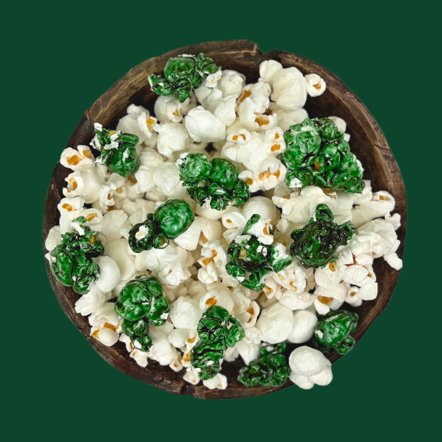 Bowl of dark green candy-coated and white salted popcorn