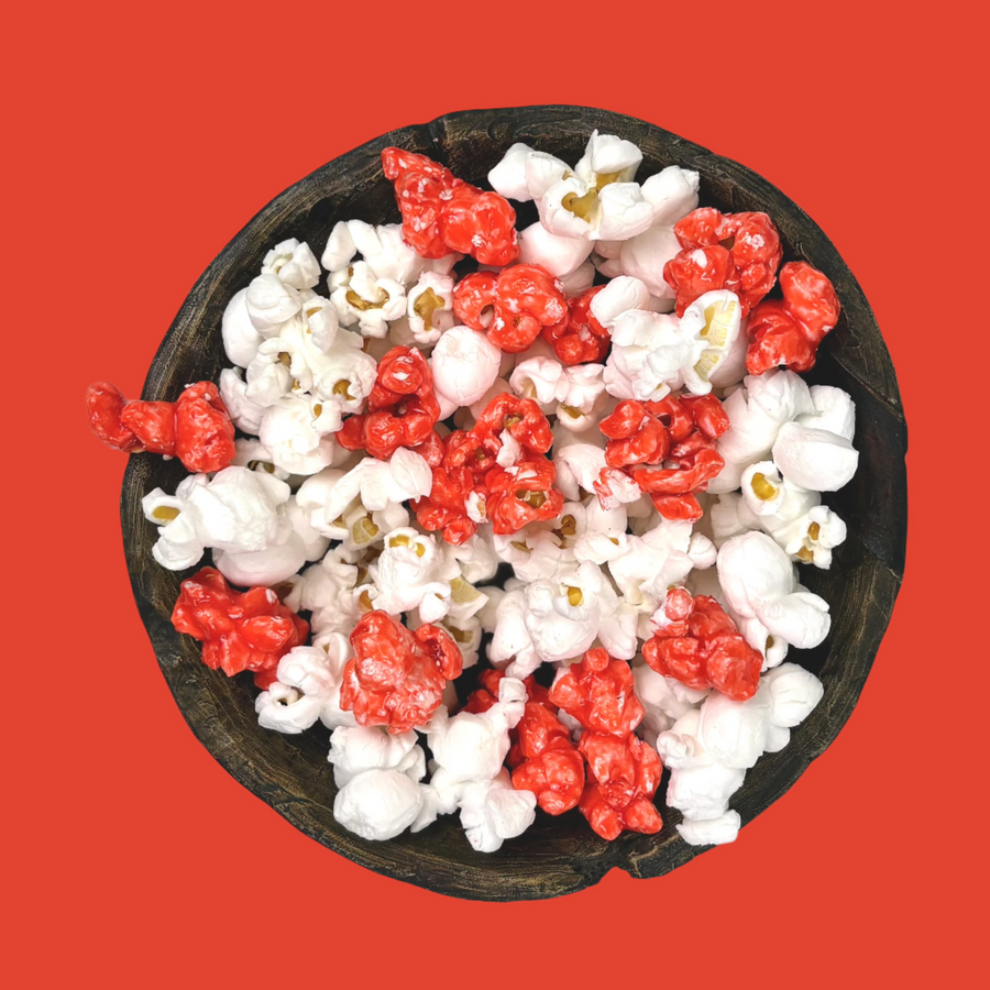 Bowl of red candy-coated and white salted popcorn