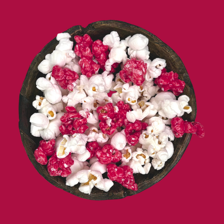 Bowl of maroon candy-coated and white salted popcorn