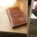 Closed Personalized Lifetime Leather Field Notes Wallet on a table.