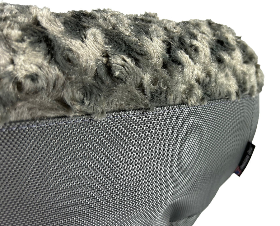 Close-up of charcoal fleece and side panel on a Furvana round dog bed