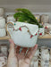 A handmade ceramic mug featuring a festive garland design with red, green, and gold accents and a gold handle, perfect for holiday celebrations and gifts.