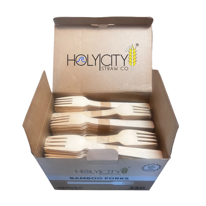 Close-up view of a bunch of unwrapped Holy City Straw Co. bamboo forks, arranged in a row.