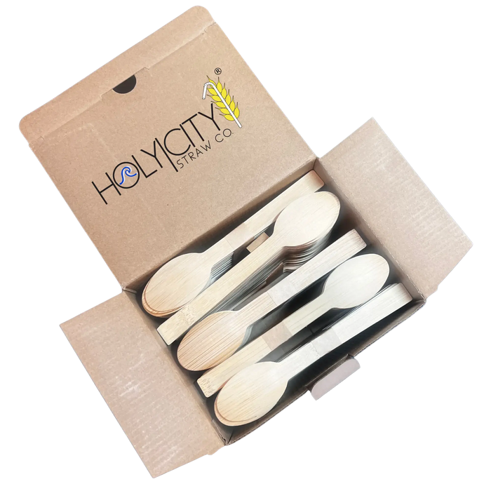 Holy City Straw Co. unwrapped bamboo dessert spoon next to lemon sweet plate