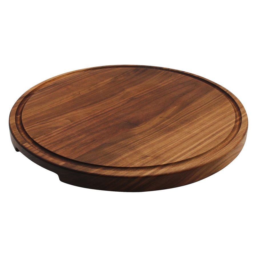 Thick round walnut board with a perimeter juice groove