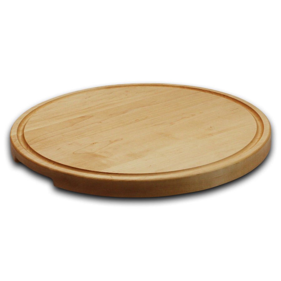 Thick round maple cutting board photographed at a low angle