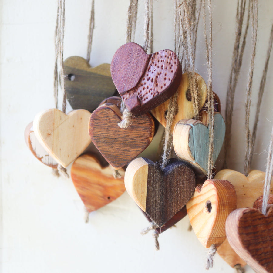 Wooden heart charms hanging on natural twine.