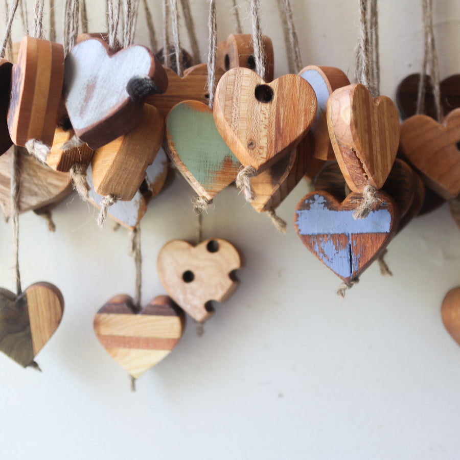 Wooden heart charms hanging above printed reflection cards.