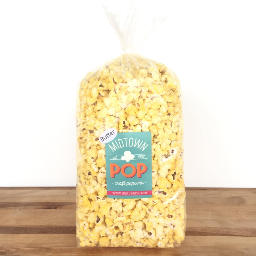 Bag of butter-flavored popcorn on a wood surface