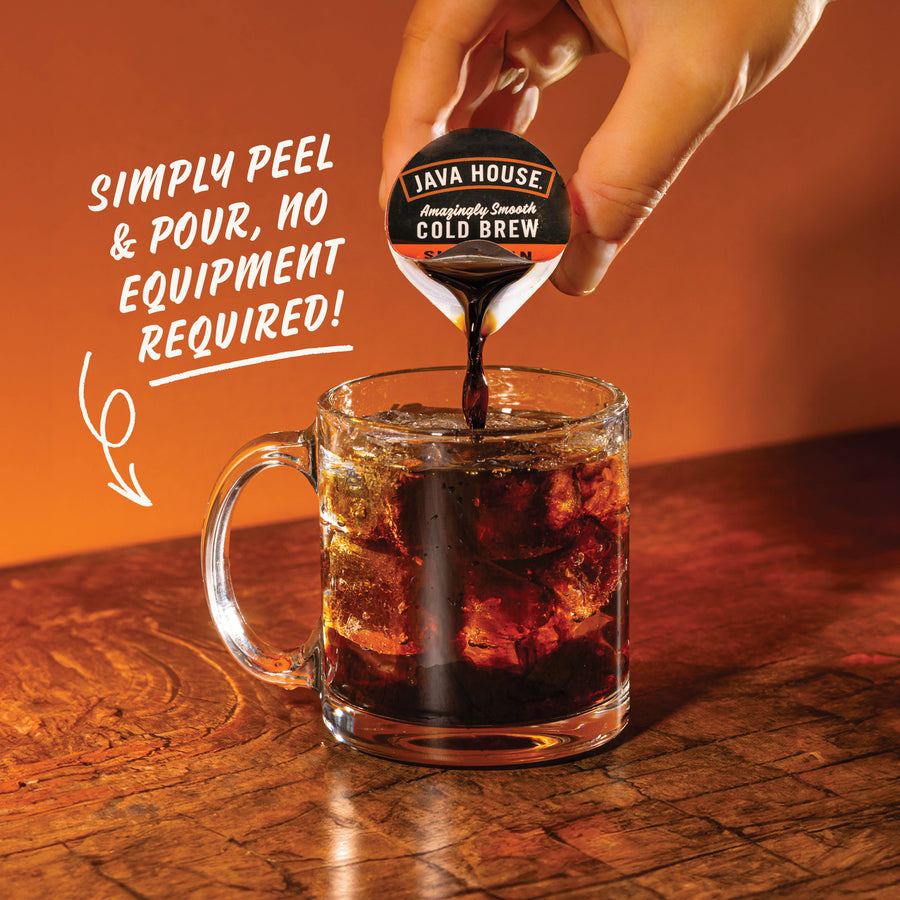Hand pouring Sumatran coffee concentrate over ice
