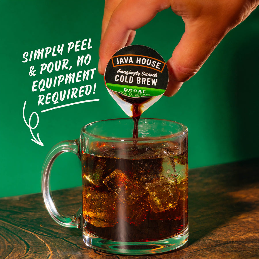 Hand pouring decaf concentrate into iced water