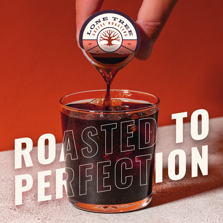 Hand pouring Daily Delight coffee into a glass