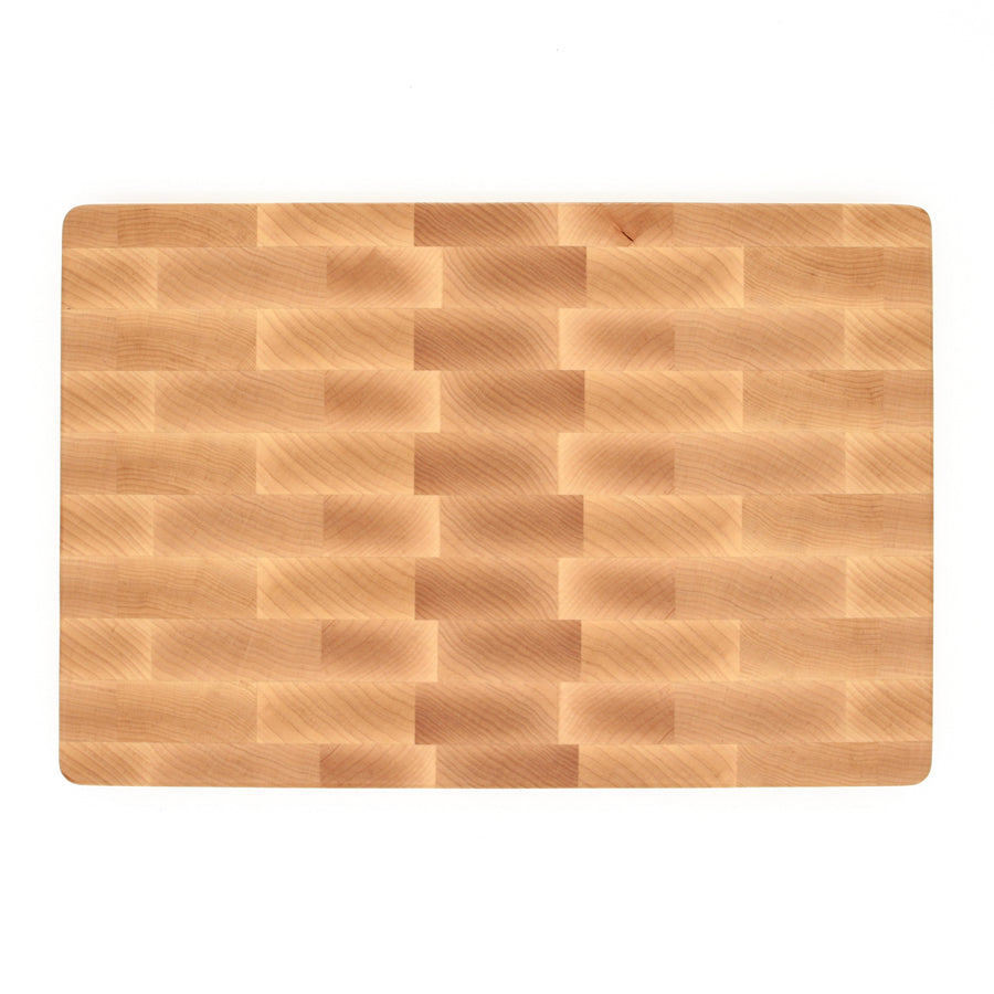 Overhead view of maple end-grain blocks in a rectangular cutting board