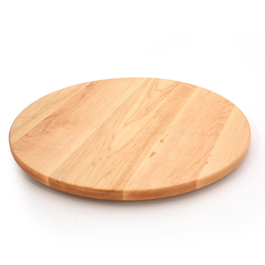 Round maple cutting board on a white background