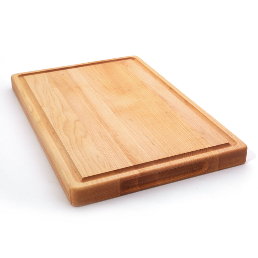 Thick maple board with a juice groove, angled view