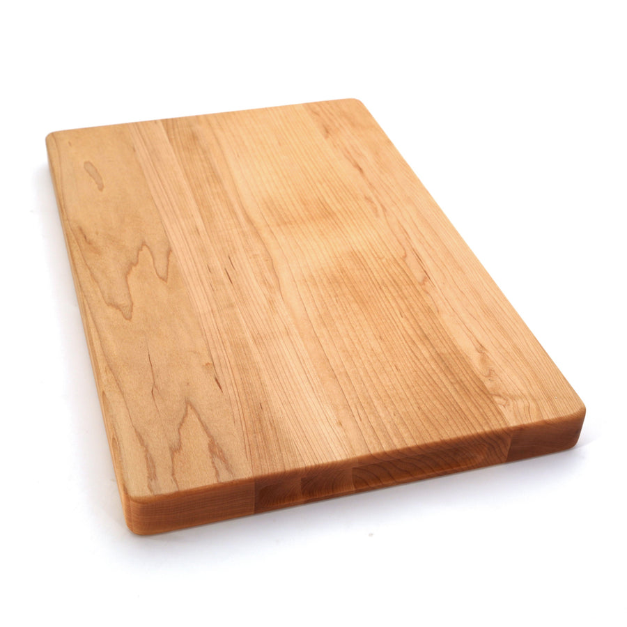 Plain maple cutting board photographed at an angle