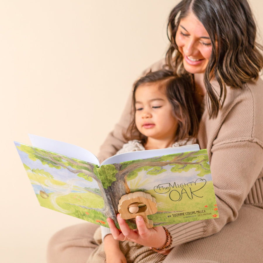 Adult and child reading The Mighty Oak illustrated children’s book