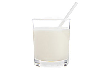 Glass of prepared milk with a straw, serving suggestion