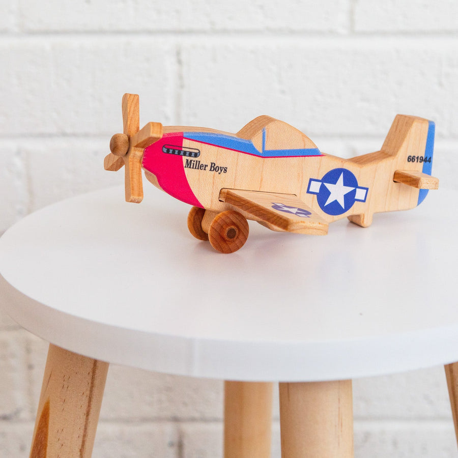 Wooden toy airplane displayed on a small round table