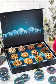 12 Days of Gourmet Nuts Winter Wonderland Selection in open box with alpine scene, showcasing assorted delicious nut snacks