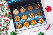 Gourmet nut selection box with 12 compartments, perfect for a cozy après ski treat by the fire. Variety of nuts include cashews, almonds, and more