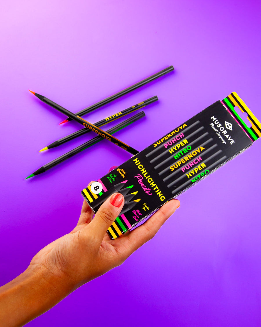 Hand holding the highlighter pencil box over a purple background