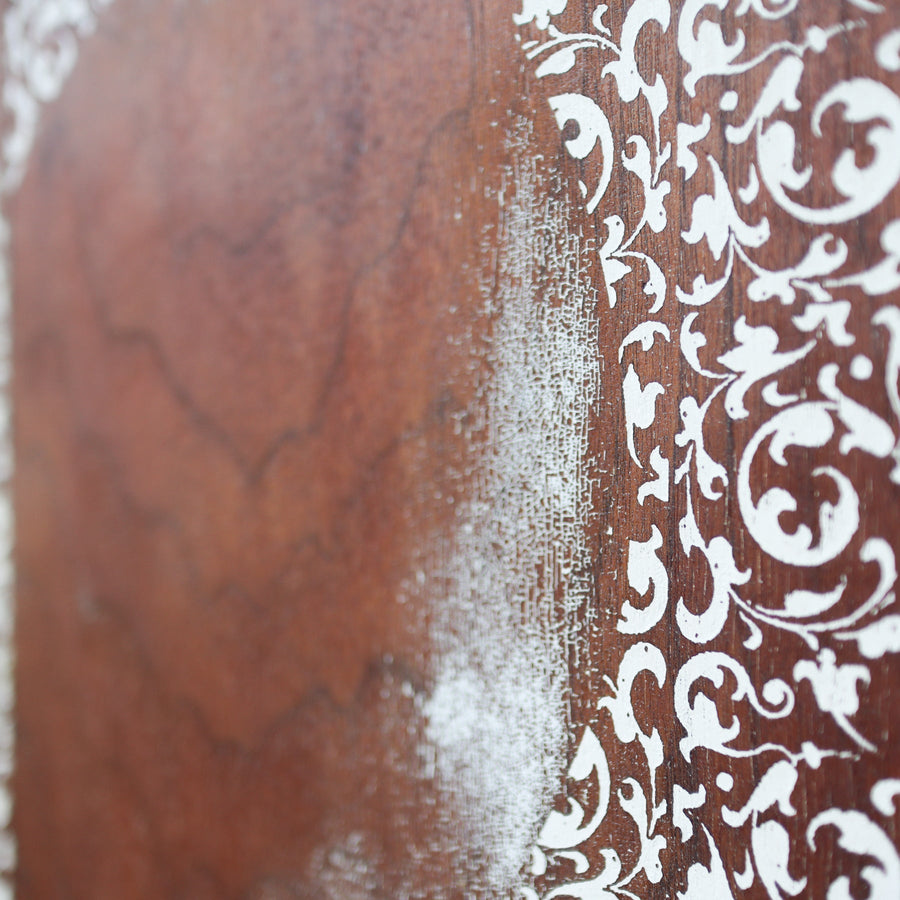 Heart of Filigree art print with a pale ornamental heart against brown wood imagery.