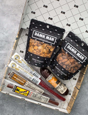 Damn Man Nuts & Exotic Meats Box containing Texas peanuts, hunter's almonds, wild boar sausage, and an assortment of meat sticks