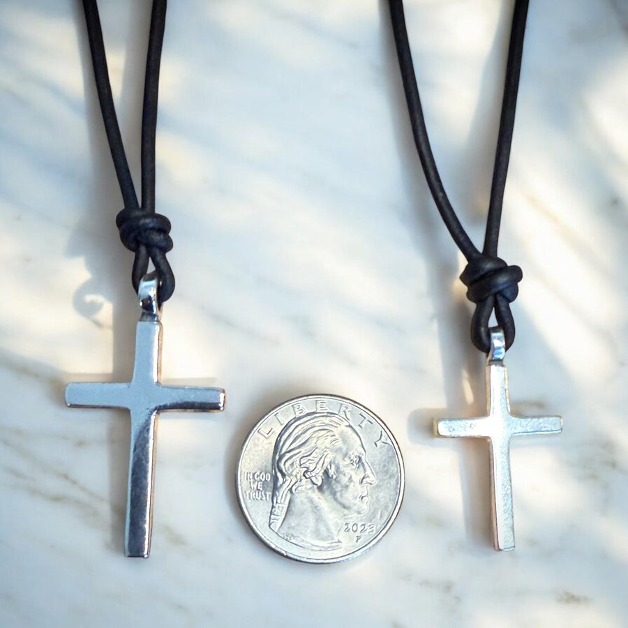 Large and medium Classic Cross pendants compared beside a coin