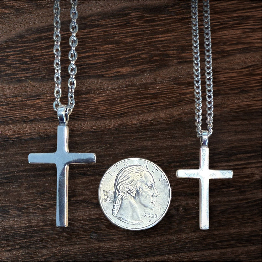 Large and medium Classic Cross pendants compared beside a coin