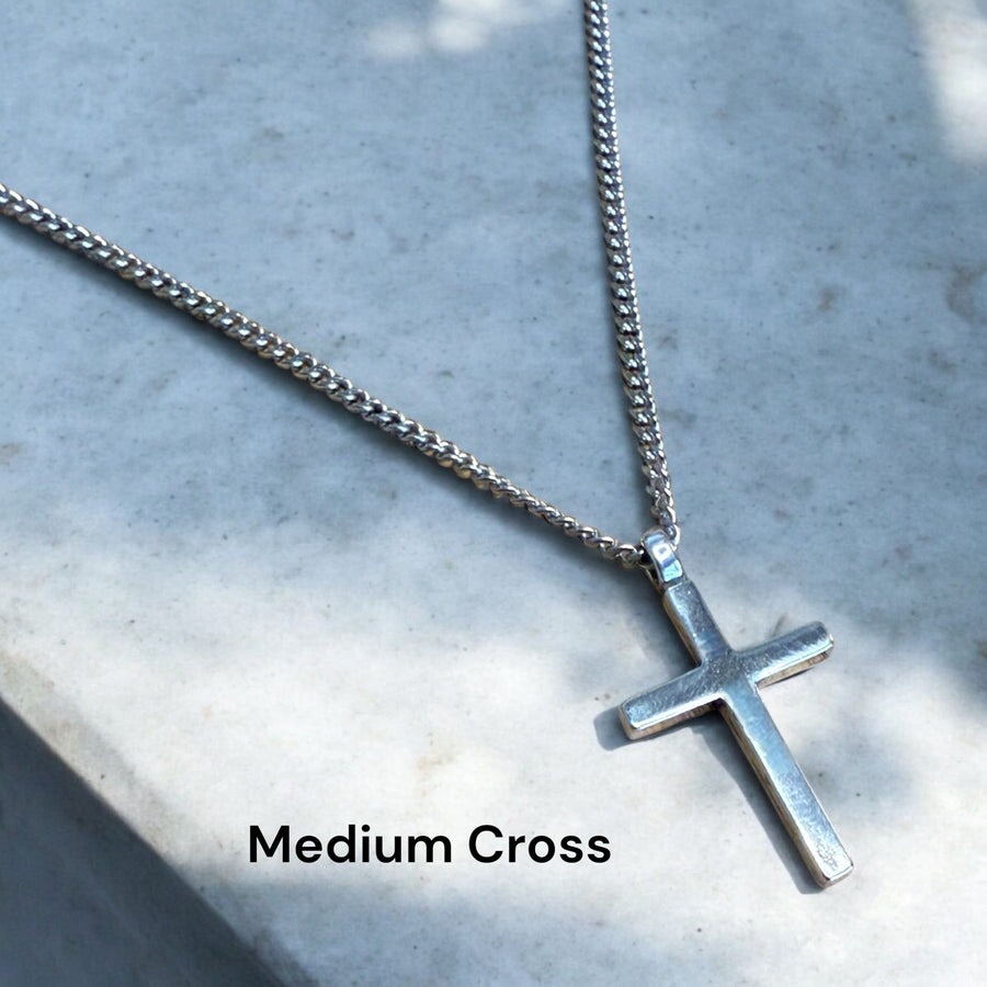 Medium Classic Cross pendant and chain on pale stone