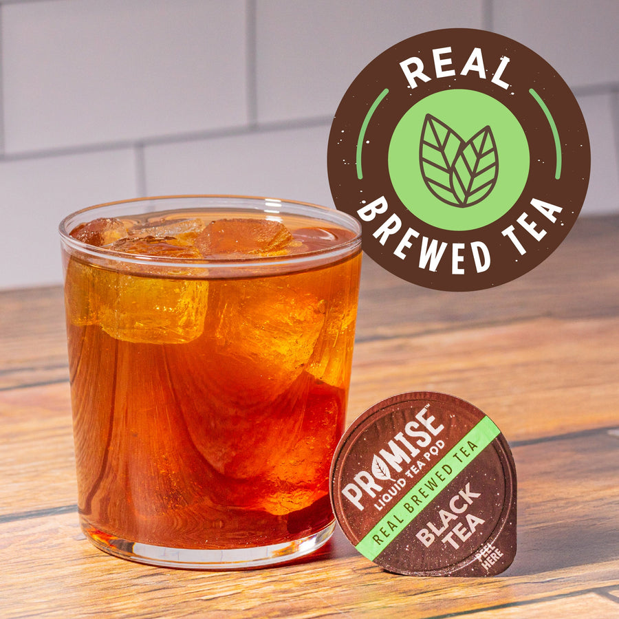 Prepared black iced tea beside a pod