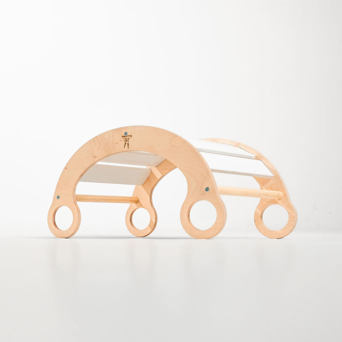 Child enjoying imaginative play with a rocker climber arch