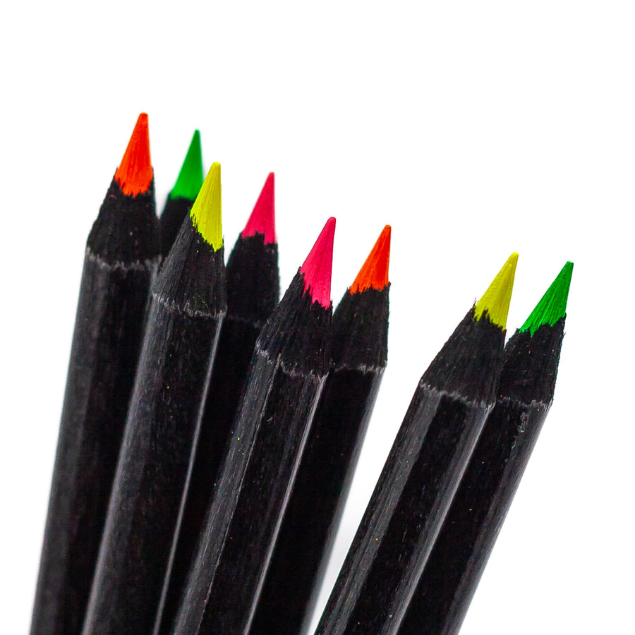 Sharpened highlighter pencil tips in pink, yellow, green, and orange