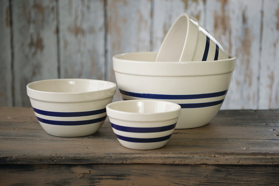 Blue-striped stoneware shoulder bowls in several sizes displayed together
