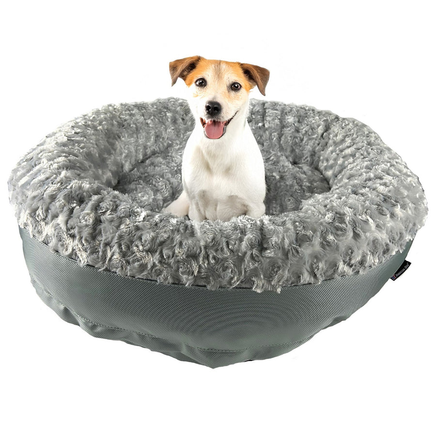Dog sitting in a silver Furvana round bolster dog bed
