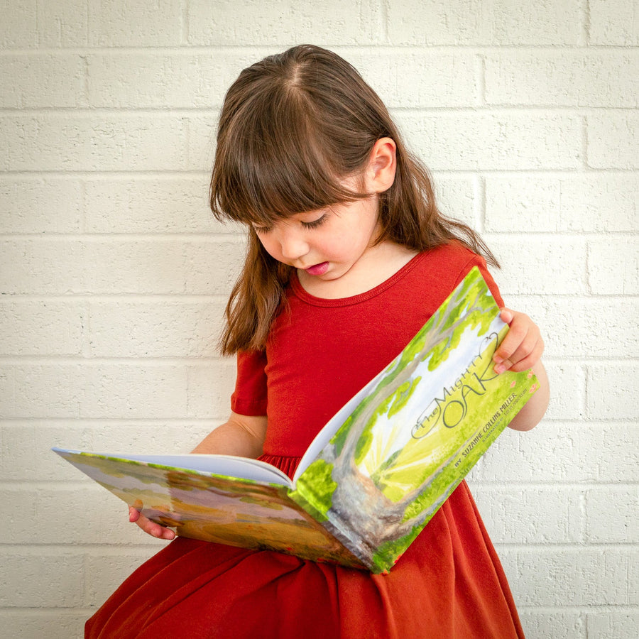 Child reading The Mighty Oak illustrated children’s book