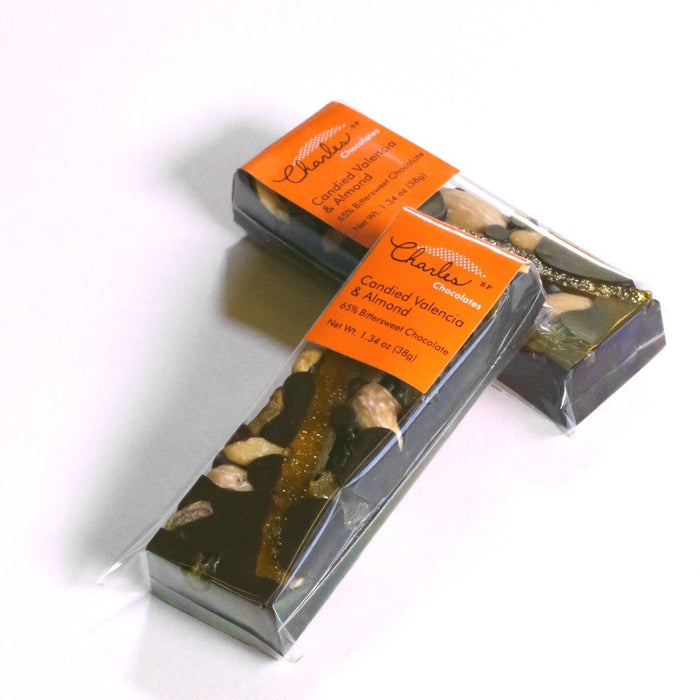 Bittersweet chocolate Valencia orange and almond bar with opened packaging