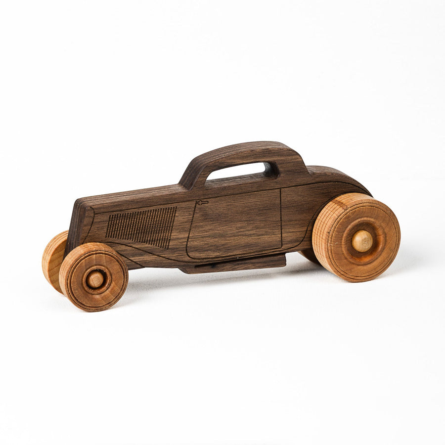 Side view of a walnut hot rod wooden toy car