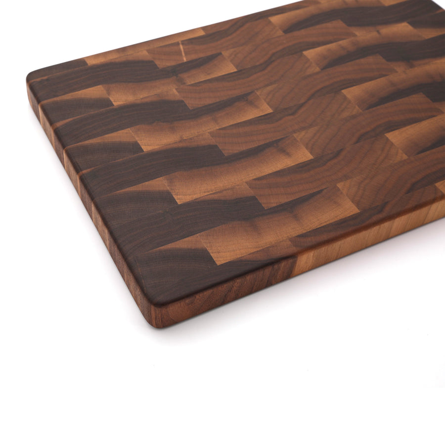 Walnut end-grain board photographed at an angle on white