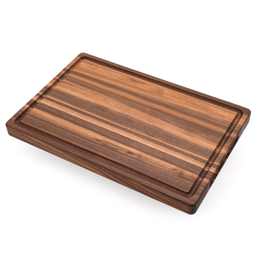 Walnut edge-grain board with a juice groove, angled view