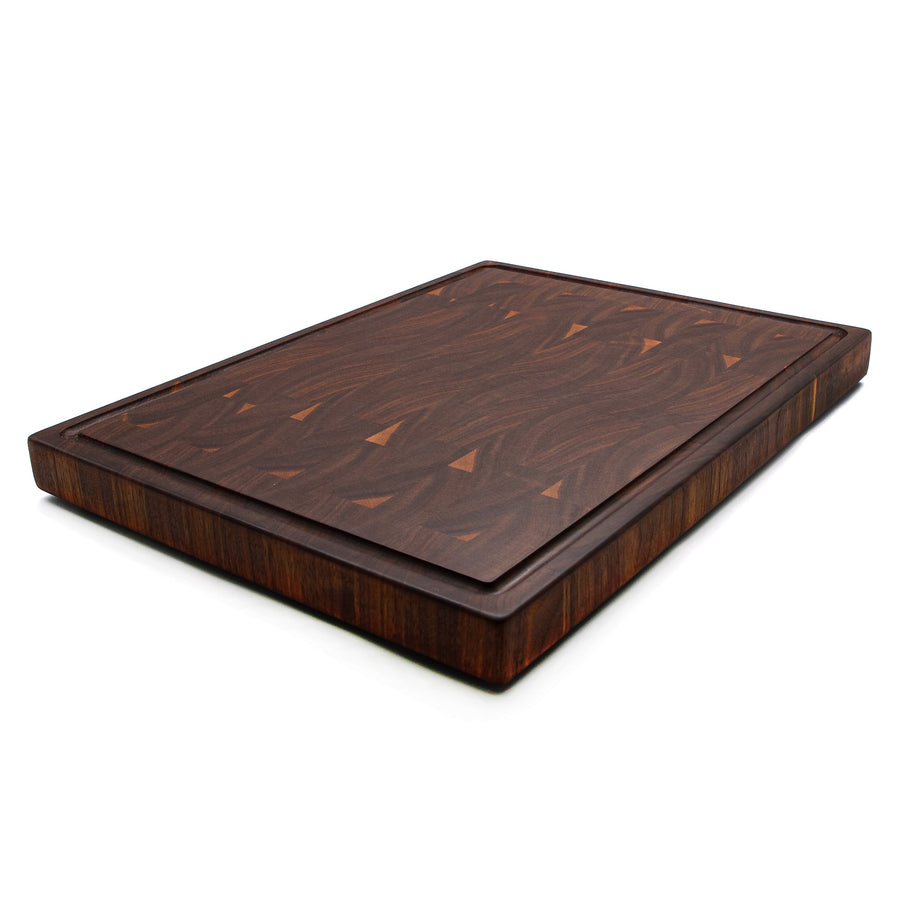 Thick walnut end-grain butcher block photographed at an angle