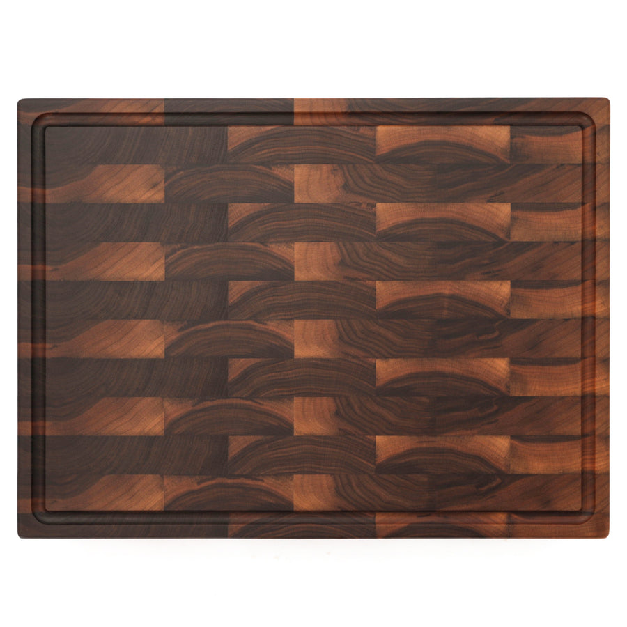 Walnut end-grain cutting board with a juice groove, overhead view