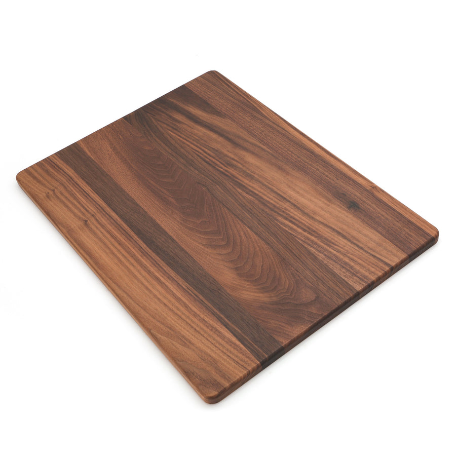 Walnut rectangular cutting board photographed at an angle