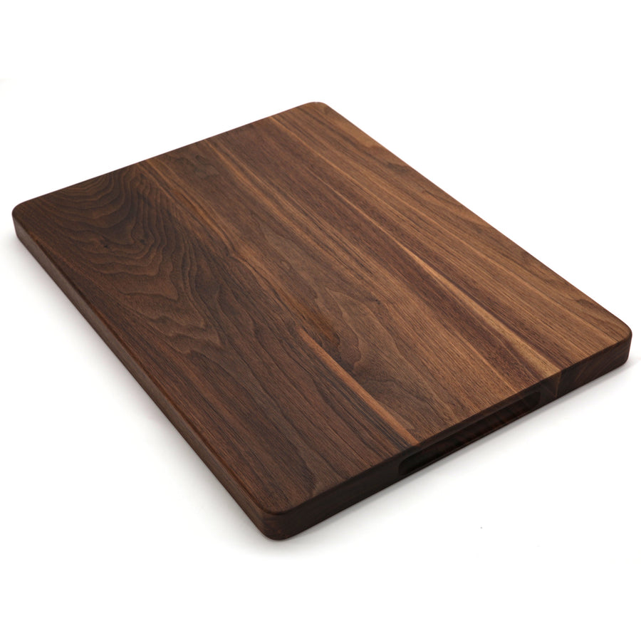 Walnut cutting board with a plain surface, angled view