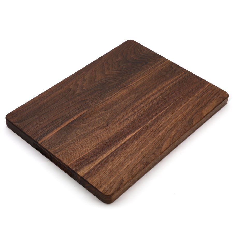 Thick walnut cutting board photographed at a low angle