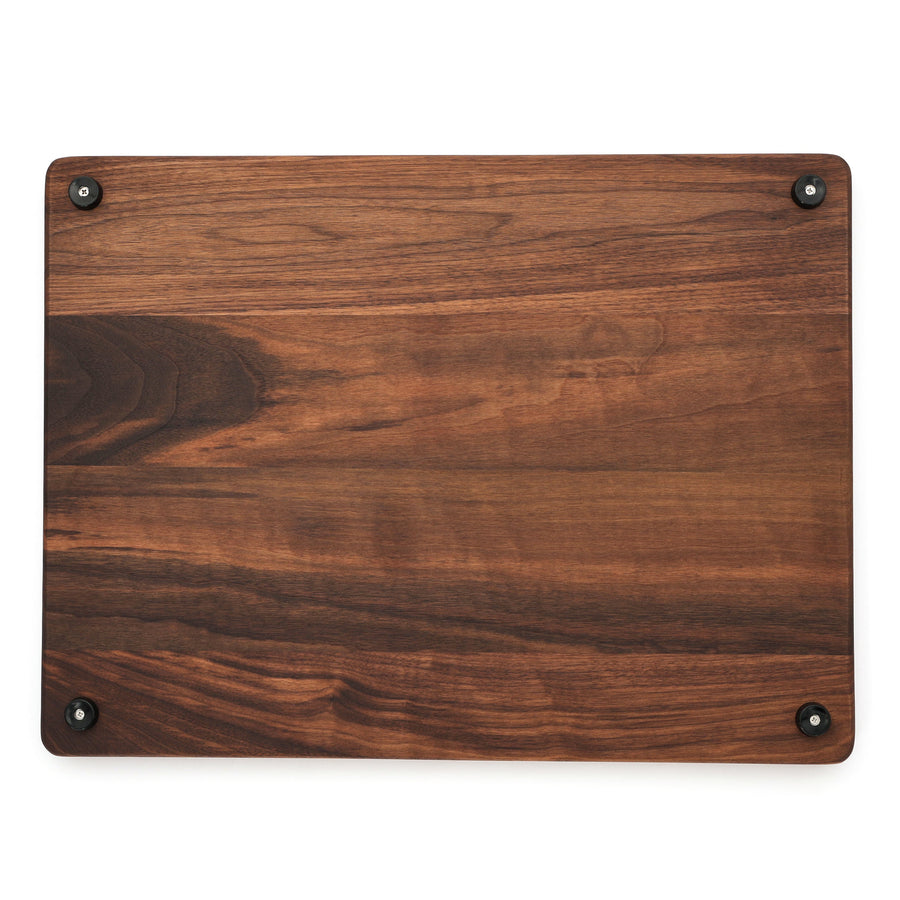 Walnut board underside showing four installed rubber feet