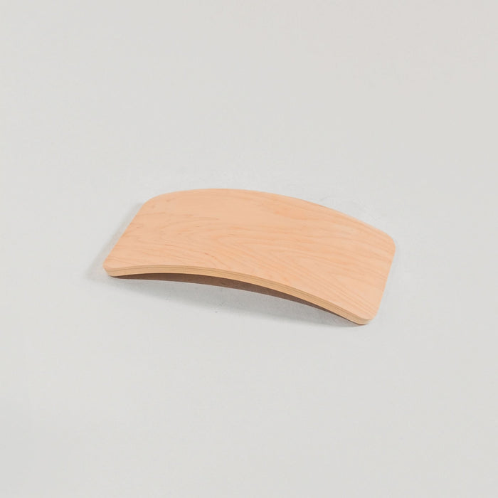 Child learning balance with wobble board